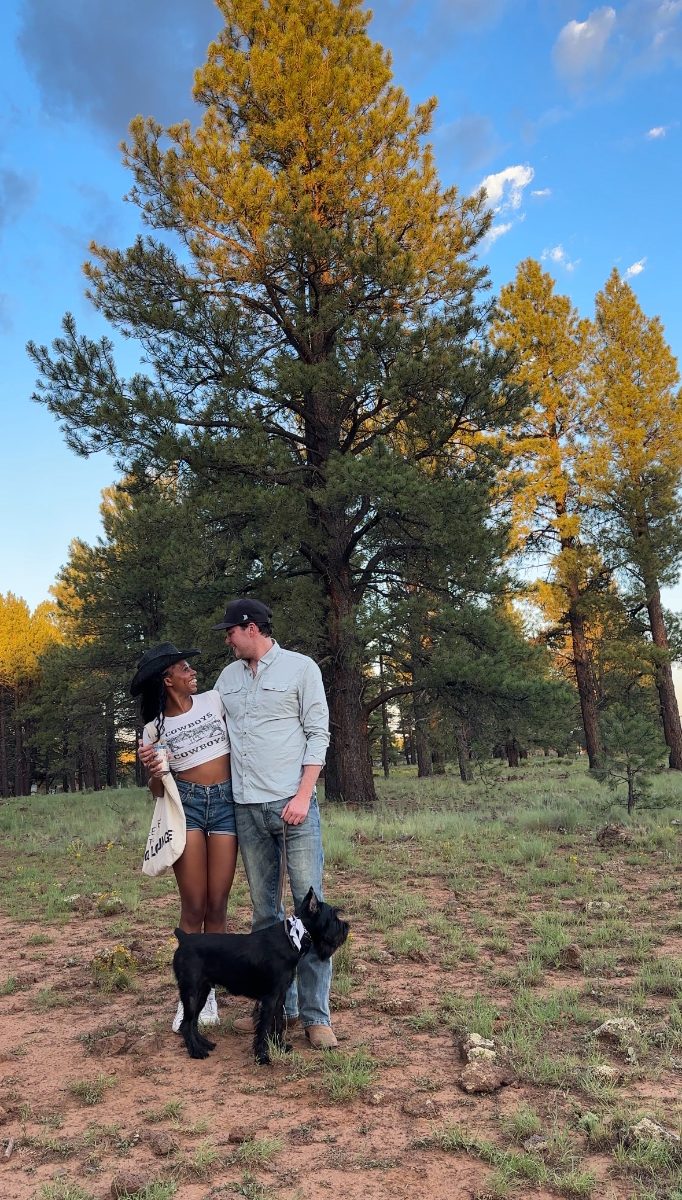 Couple and dog under the pines